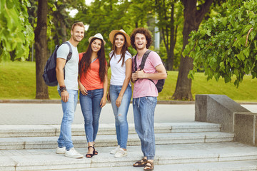 Group of people smiling on a city street in summer.