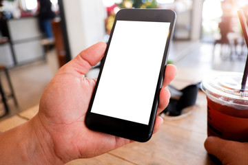 Mockup picture of business man’s hands holding smart phone with white blank screen in modern place.