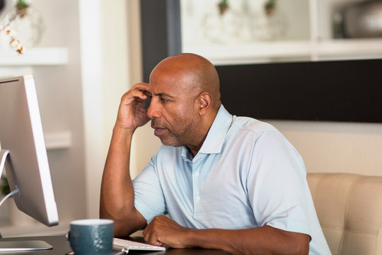 Mature African American Man Working From His Home Office.