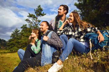 A group of tourists resting while sitting in a forest.