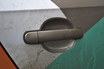 door handle on a dirty car-sharing car door