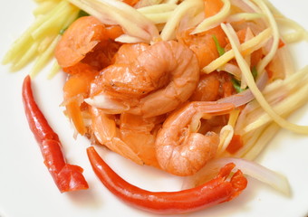 spicy dried shrimp with slice mango fruit salad on plate