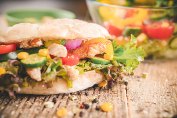 Delicious sandwich on wooden table. Tasty fast food