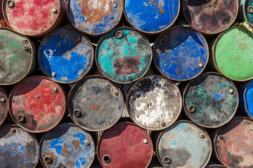 Old fuel tanks. Stacked rusty barrels. Old oil cans background. Ecology problems Environmental pollution concept.