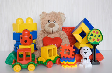 plush bear with different plastic toys