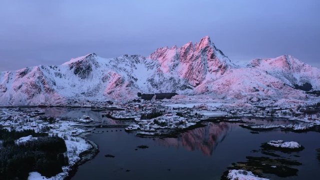 Pinky sunrise in famous lofoten islands which are north of norway. Ballstad town has a long history with fishing of famous cod and salmon. Because of gulf stream winter is calm and beautiful with snow