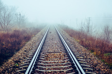 Fototapeta na wymiar Railway track disappear in fog