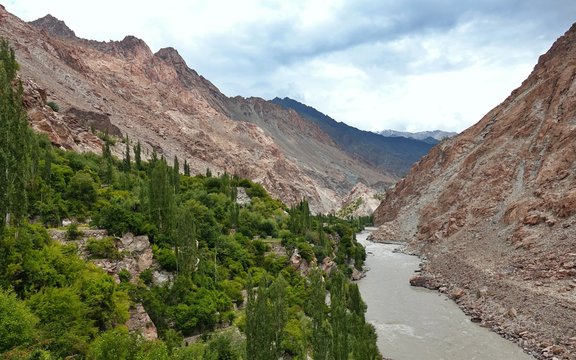 Indus river with bare mountains behind next to Leh, Ladakh