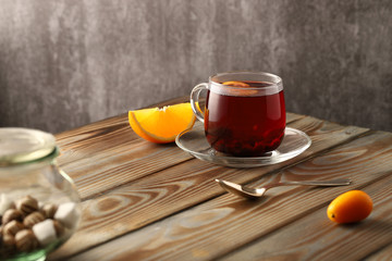Blackcurrant berry tea, with the addition of orange juice and slices of kumquat. A tasty and healthy drink rich in vitamins.