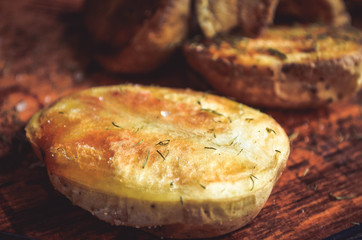 baked potatoes with bacon and salt on a wooden kitchen Board