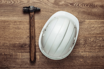 Hammer and construction helmet on home. Repair in the apartment. Top view
