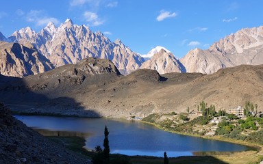 The warm Borith Lake with the Passu cones peaks in the background - Trekking in Pakistan 2019