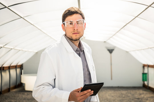 Portrait of biologist in empty greenhouse with tablet. Montana, USA