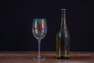 Bottle of white wine with glass