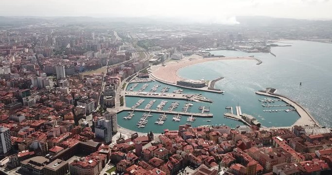 Panoramic aerial view of Gijon on Atlantic ocean coast overlooking of marina with moored pleasure yachts, Spain