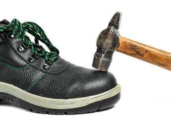 Work leather shoes and hammer isolated on white background. Strength check, worker safety