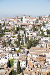 Fototapeta na wymiar View of a Mediterranean town with all the white houses and buildings in Granada, southern Spain,