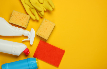 Set of products for cleaning the house on a yellow background. Top view. Copy space