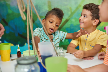 Obraz premium Kids having fun on Birthday party. Happy kids with animator in playroom. Children activities concept.