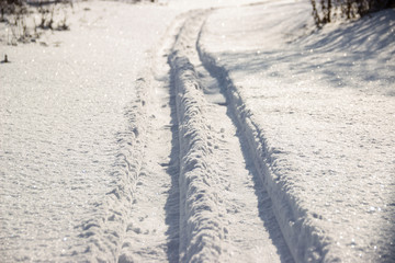 Fototapeta na wymiar Glistening snow track