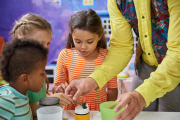 Kids doing a chemical experiment in playroom. Kids having fun at childrens entertainment center....