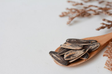 Sunflower seeds in wooden spoon with copy space for product or text.