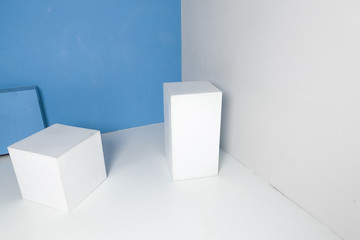 white geometric shapes in room with blue wall