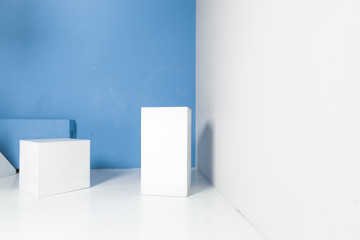 white geometric shapes in room with blue wall
