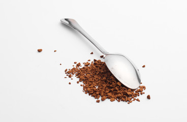 Metal spoon with granulated coffee on a white background