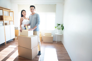 asian couple receive shipment from delivery man, order box shipping from online store website to...