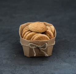 Shortbread oatmeal cookies with milk on a dark gray background