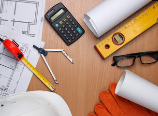 Creative layout of architects with roll drawings, architectural project plan, engineering tools and...