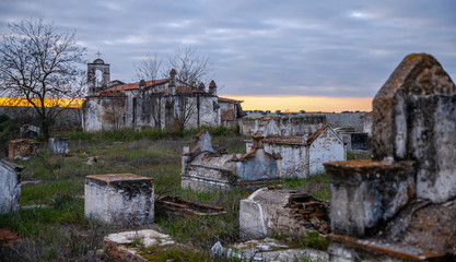 Abandoned church ruin and cemetery overgrown landscape