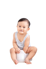 Cute baby sitting on chamber pot, Potty training concept, isolated on white background with clipping path.