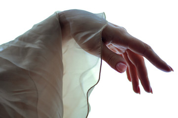 Delicate female hand and silk fabric.