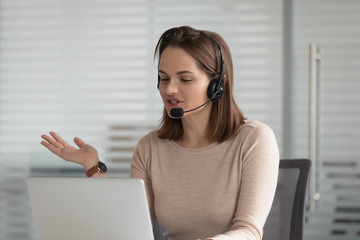 Female call center agent in headset consult client online