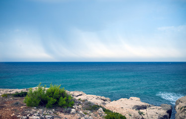 Fototapeta na wymiar Stormy clouds over the Mediterranean sea view from rocks