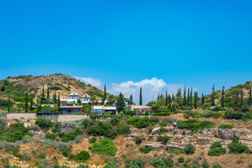 Fototapeta na wymiar Cyprus. Resorts. Pissouri village. Resorts at the foot of the mountains. Hotels in a hilly area. Panorama of Pissouri village. Mediterranean seacoast. Tourism in Cyprus. Guide to Cyprus.
