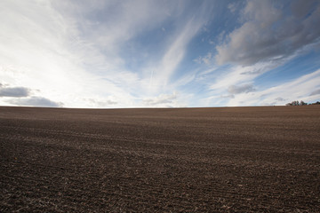 Plowed field prepared for planting crops at sunset