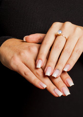 Female hands with tender pink manicure, close-up. Beauty and fashion.