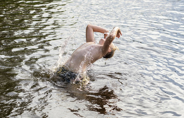 A young man emerges from the water