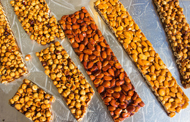 Walnut, almond and Pistachio nut bars on the table, Mediterranean sweets.
