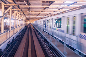 Fototapeta na wymiar Train travels at high speed. Interior of the Tokyo railway station. Japan. Subway station. Concept - high-speed trains. Traveling by train. Covered railway. Rails. Train passing station.