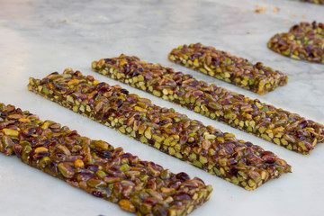 Pistachio nut sweet bars on the stone table, Mediterranean sweets.