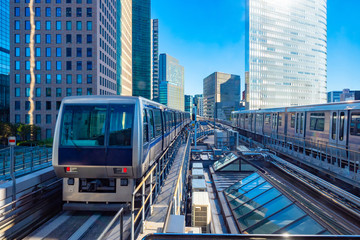 Naklejka premium Tokyo. Japan. Unmanned train. Automated guideway transit. Train without a driver traveling by rail. Railways in Japan. Tourism in Tokyo. Traveling in Japan by train. Modern Tokyo. Railroad bridge