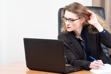 Girl works with a laptop. Accountant fills out a report. Woman s