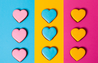 Three strickt rows of colorful gingerbread cookies