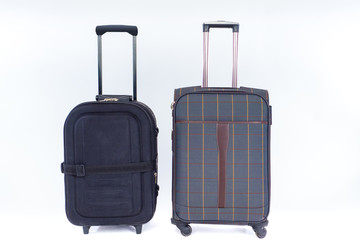 Two bags on a white background. Two large suitcases stand nearby. Concept - suitcases for long trips. Bags for transporting personal items. Sale suitcases on wheels. Concept - Relocation Assistance