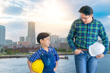 Father builder and son is walking together in modern City Yokohama for industry and family boding...