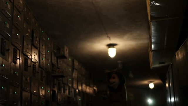 Male walking in costume of bear in electrical room.